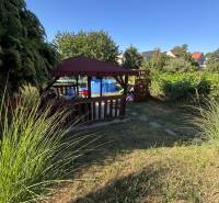 Summer terrace with a gazebo and a pool on Obrancov Mieru Street in Šahy by a 3-room apartment.
