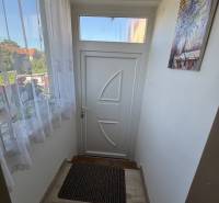 Entrance hallway in a 3-room apartment with white doors and a doormat.