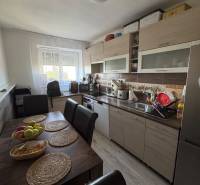 A kitchen in a 3-room apartment with a dining table and light furnishings.