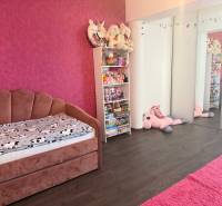 Children's room in a 4-room apartment with pink furniture and toys.