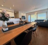 Dining room with flowers in a 4-room apartment and a view of the living room.