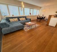 Living room in a 4-room apartment with furniture and wooden flooring.