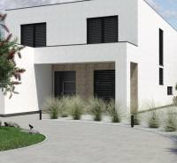 A family house in Opoj with a minimalist garden and a landscaped entrance.