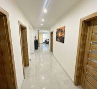 A hallway with wooden doors and a tiled floor in a family house.