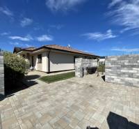 A family house in Prešov with a paved courtyard and a grassy area.