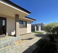 A family house in Prešov with a terrace, landscaped garden, and paved walkway.