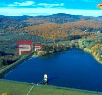 A lake surrounded by an autumn landscape in the Pezinok area, suitable for residential plots.