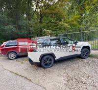 Cars parked by the gate, surrounded by trees, Property - housing Pezinok.