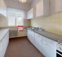 A kitchen in a family house with a gas stove and plenty of storage space.