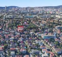 Aerial view of family houses in Bratislava, green area and city skyline.