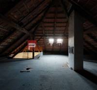 Attic space in a family house with wooden beams and skylights.