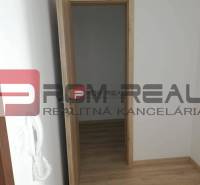 Opening wooden doors lead from a 2-room apartment on Slavomírova Street, with bright parquet floors.