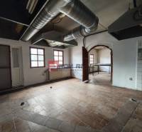 A space with tiles and ventilation pipes, suitable for commercial premises.
