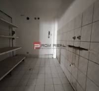 Retail spaces with white tiles and wall shelves.
