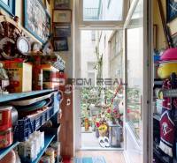 A covered balcony in a 2-room apartment with decorations and a view of the inner courtyard.