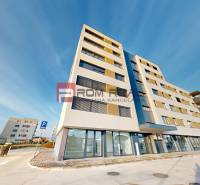 Commercial premises in Pezinok on Obchodná Street in a modern building with glass displays.