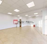 Brightly lit commercial spaces with tiled floors and glass doors.