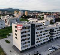 Commercial premises on Obchodná Street in Pezinok, surrounded by apartment buildings and greenery.