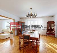A family house with a stylish living room, wooden furniture, and parquet flooring.