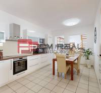 A family house with a spacious kitchen, dining table, and built-in appliances.