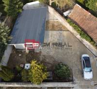 Aerial view of a family house yard in Pezinok with a parked car and a garage.