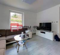 Living room with a corner sofa, coffee table, and television in a family house.