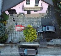 A family house in Píla with a spacious yard, parked cars, and a well-maintained garden.