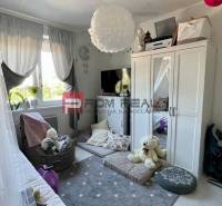 Children's room in a 3-room apartment with toys, a bed, and a wardrobe.