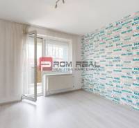 A room in a 4-room apartment with open balcony doors and interesting wallpaper.