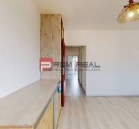 A room with a wooden floor and a built-in wardrobe in a 4-room apartment.