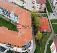 Aerial view of residential blocks on Muškátová Street in Pezinok with a sports field.