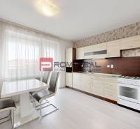 Kitchen in a 4-room apartment with a dining table, chairs, and kitchen unit.