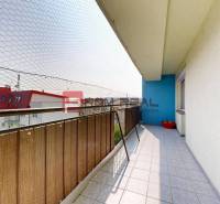 The balcony of a 4-room apartment on Muškátová Street in Pezinok with a view of the roofs.