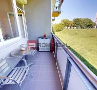 The balcony of a 1-bedroom apartment at Koprivnicka 9/F in Bratislava IV with a view of greenery.