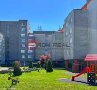 Apartment complex with a playground and benches at Koprivnická 9/F in Bratislava IV.