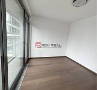 Interior with wooden flooring and large windows in commercial spaces.