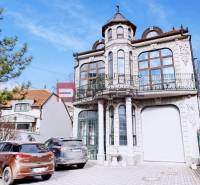 The building on Ľ. Podjavorinská Street in Trnava with an ornate balcony and decorative facade.