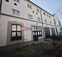 On Ľ. Podjavorinská Street, there is a building with large windows and historical details.