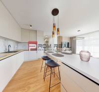 A kitchen in a 2-room apartment, bright interior with bar stools and pendant lighting.
