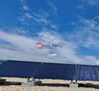 Solar panels against a blue sky. On Pezinok street, a 2-room apartment is waiting for a new owner.