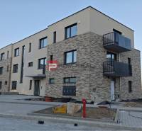 A new building with a brick facade on the street in Pezinok includes 2-room apartments.