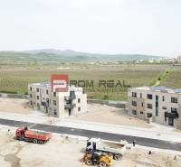Apartment building construction with vineyards on Limbašská Road in Pezinok, offering 2-bedroom apartments.