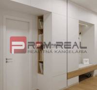 Interior with white built-in wardrobes, view on Limbašská Street and a 2-room apartment.