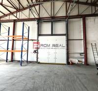 Warehouses and halls with shelves and a garage door, empty space ready for use.