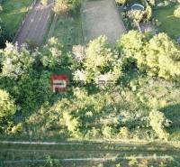 Aerial view of greenery and houses in Budmerice on Poľná, ideal for residential plots.