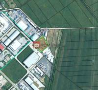 Aerial view of the production facilities in Pezinok surrounded by agricultural landscape.