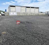 Production premises in Pezinok surrounded by a gravel area and industrial buildings.
