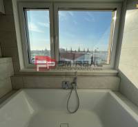 A bathroom with a bathtub and a window in a 4-room apartment.