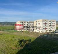 Apartment buildings on Obchodná Street in Pezinok with a view of the surrounding nature.