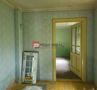 Interior with wallpaper and old flooring, Properties - living. It adds a rustic atmosphere.